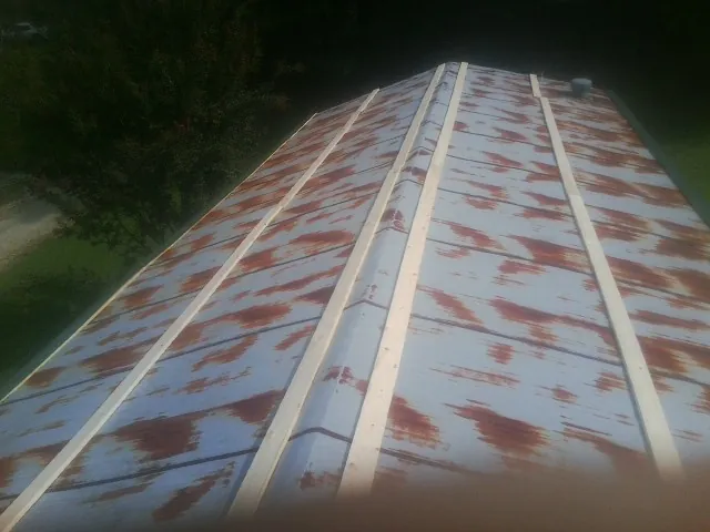 Rusted metal roof panels with new wood purlins before replacement — Storm Damage Roof Repair in Rancocas by Roofing Brothers